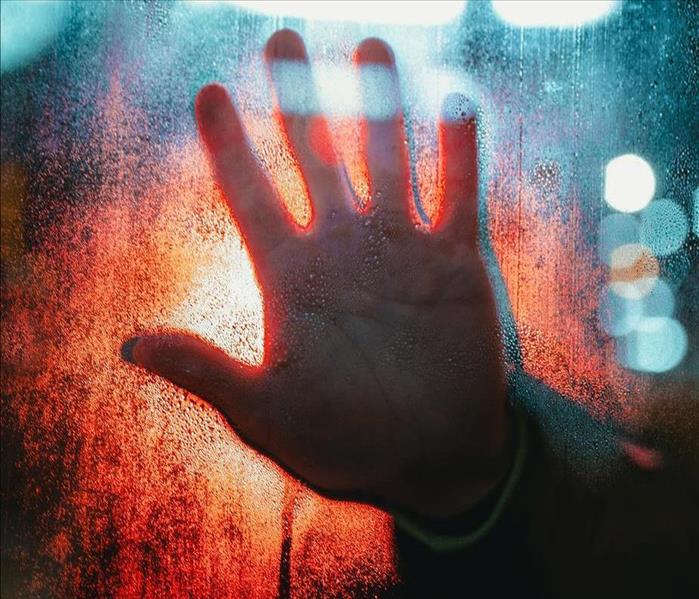 hand behind glass